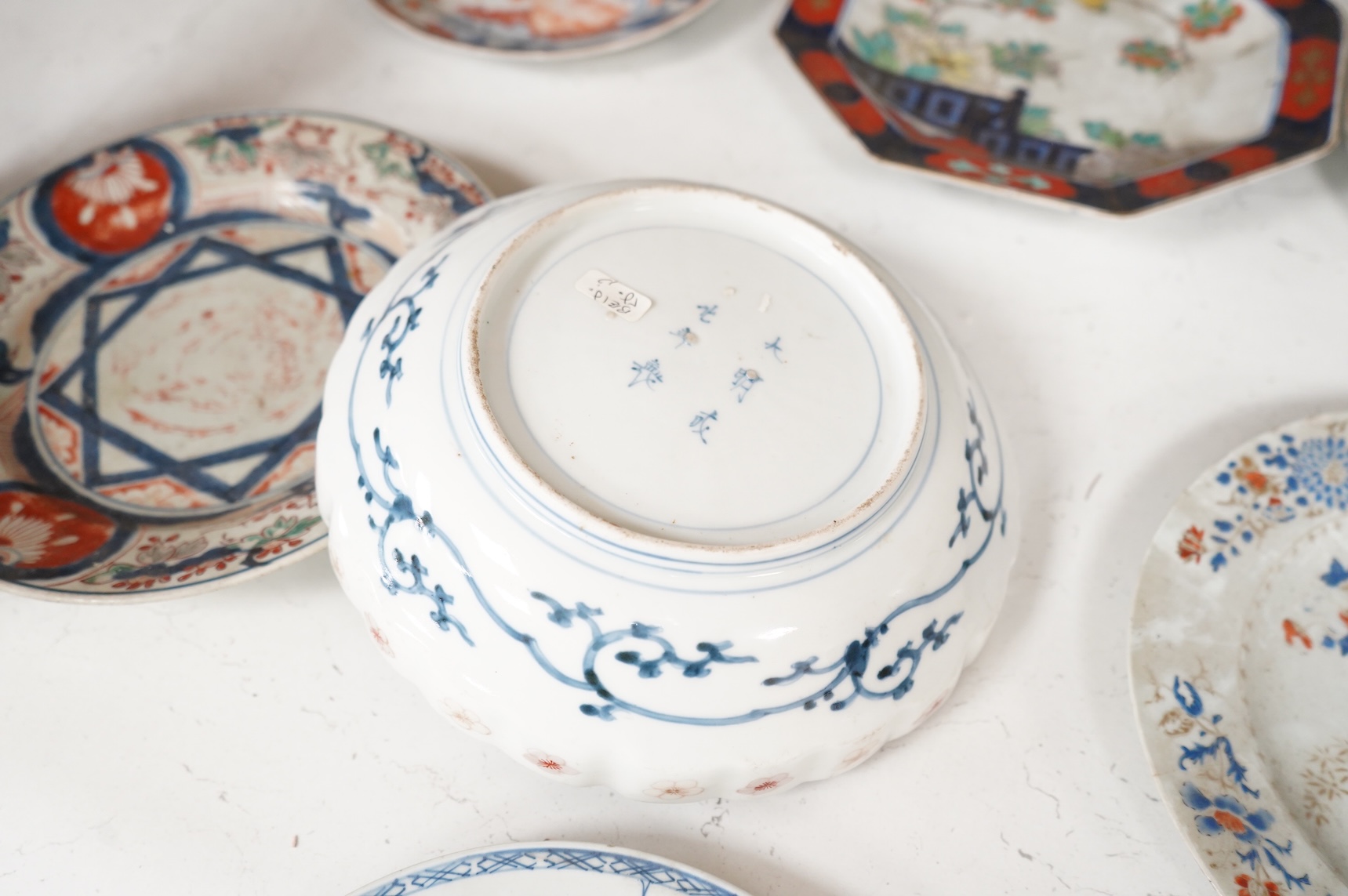 Six 19th century Japanese plates and a bowl, mostly Imari pattern, the octagonal dish with Koransha mark for Fukagawa, largest 24cm in diameter